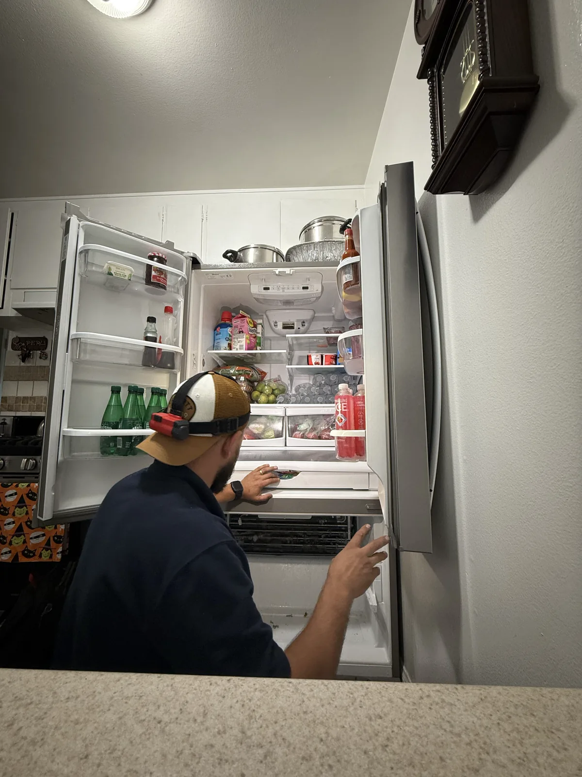UKS PRO technician inspecting an open refrigerator