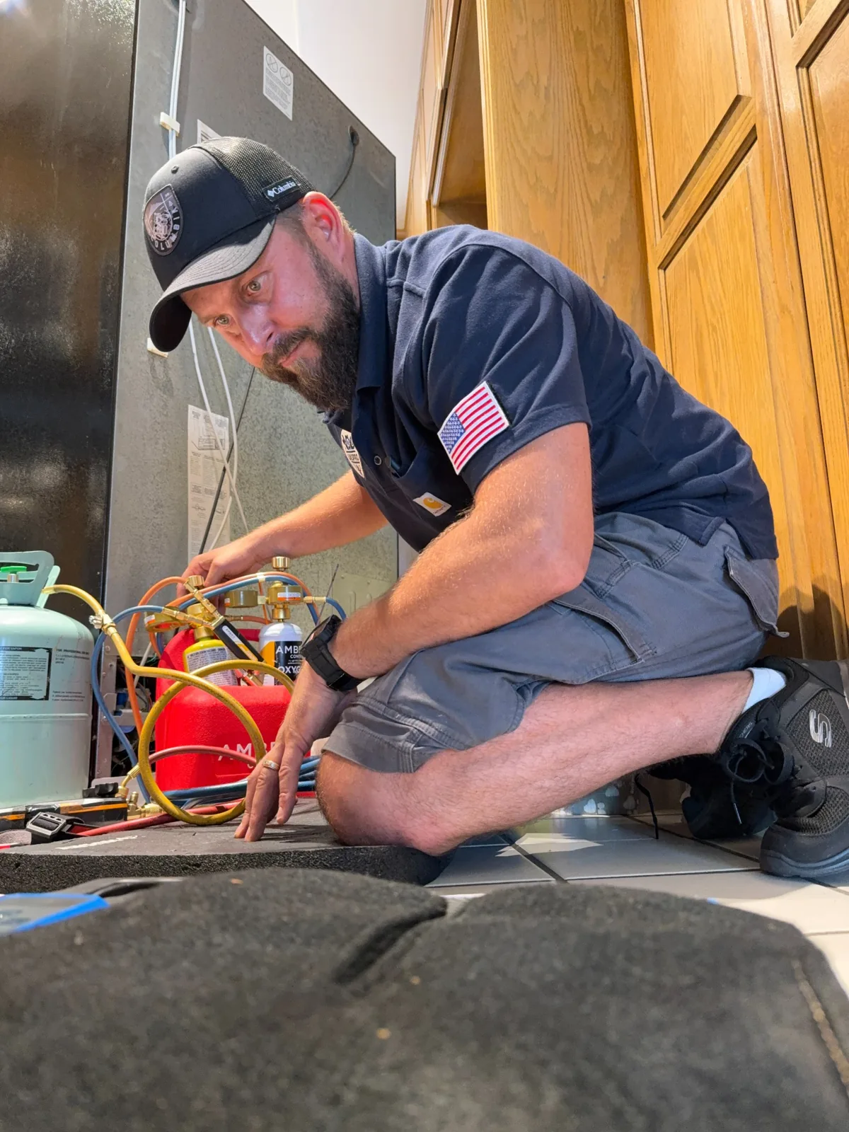 UKS PRO technician working beside a refrigerator